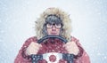 Man in winter clothes with a steering wheel, snow, blizzard. Concept car driver Royalty Free Stock Photo