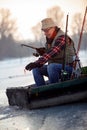 Man on winter fishing on the frozen lake Royalty Free Stock Photo