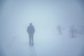 Man in winter fog mountain road Royalty Free Stock Photo