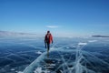 Man in winter jacket travel on frozen Baikal lake in Irkutsk, russia in February