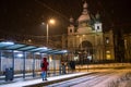 man at winter snowed night at railway station waiting for tram Royalty Free Stock Photo
