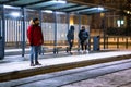 man at winter snowed night at railway station waiting for tram Royalty Free Stock Photo