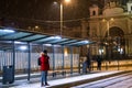 man at winter snowed night at railway station waiting for tram Royalty Free Stock Photo