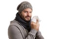 A man in winter time with disease has to sneeze and blow into a handkerchief isolated on white background Royalty Free Stock Photo