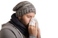 A man in winter time with disease has to sneeze and blow into a handkerchief isolated on white background Royalty Free Stock Photo