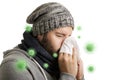 A man in winter time with virus disease has to sneeze and blows into a handkerchief isolated on white background