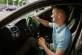 Man wipes car interior with a rag, hand auto wash