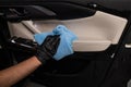 A man wipes the surface of the car interior with a microfiber cloth. Royalty Free Stock Photo