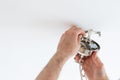 Man wiring ceiling light on white background Royalty Free Stock Photo
