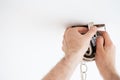 Man wiring ceiling light on white background Royalty Free Stock Photo