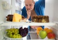 Man wish hard food rather than healthy food Royalty Free Stock Photo