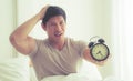 Man woke up and show alarm clock to the camera Royalty Free Stock Photo