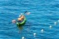 Man and Woman Kayaking in the Blue Water of the Sea - Liguria Italy Royalty Free Stock Photo