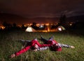 Man and woman admiring evening sky, lying on the grass Royalty Free Stock Photo