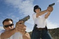 Man And Woman Aiming Hand Guns At Firing Range Royalty Free Stock Photo