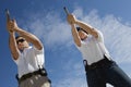 Man And Woman Aiming Hand Guns At Firing Range