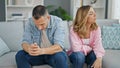 Man and woman angry couple sitting on sofa together at home Royalty Free Stock Photo