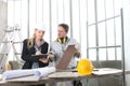 Man and woman architect interior designer and foreman worker together with tiles samples and decorative materials discussing the p