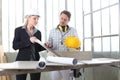 Man and woman architect interior designer and foreman worker together with tiles samples and decorative materials discussing the Royalty Free Stock Photo