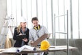 Man and woman architect interior designer and foreman worker together with tiles samples and decorative materials discussing the Royalty Free Stock Photo