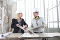 Man and woman architect interior designer and foreman worker together with tiles samples and decorative materials discussing the Royalty Free Stock Photo