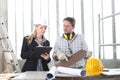 Man and woman architect interior designer and foreman worker together with tiles samples and decorative materials discussing the Royalty Free Stock Photo