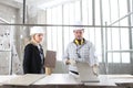 Man and woman architect interior designer and foreman worker together with tiles samples and decorative materials discussing the Royalty Free Stock Photo