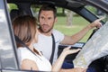 man and woman arguing inside car