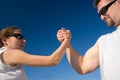 Man and Woman Arm Wrestling Outdoors