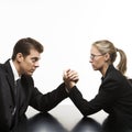 Man and woman arm wrestling on table. Royalty Free Stock Photo