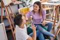 Man and woman artists couple paintng on face at art studio