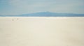 A Man and Woman Attempt to Cross White Sands