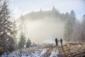 Man and woman backpackers enjoying on foggy forest mountain trail Royalty Free Stock Photo