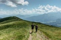 Man and woman backpackers trekking in Alps, Austria.Active healthy lifestyle.Couple in love walking together on peaks.Friends in