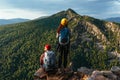 A man and a woman with backpacks on the mountain admire the panoramic view. A couple in love on a rock admires the beautiful views Royalty Free Stock Photo