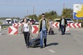 Man and woman with a bag in hands crossing Ukrainian-Russian border at the border crossing point Kalanchak