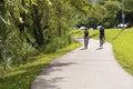 A man and a woman on bicycles ride along a path on Milwaukee`s lakefront. getting exercise for fitness