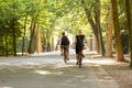 Man and woman biking in the Vondelpark on a sunny summerday in Amsterdam