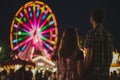 man, woman, and a blend of litup ferris wheel Royalty Free Stock Photo