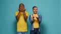 Man and woman blowing air kisses with hands and lips on studio camera Royalty Free Stock Photo