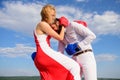 Man and woman boxing gloves fight blue sky background. She knows how to defend herself. Girl confident in her strength