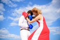 Man and woman boxing gloves fight sky background. She knows how to defend herself. Girl confident in strength power