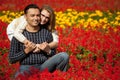 Man and woman in brackets laughing in the flowers