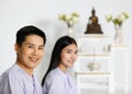 Man and woman Buddhist in white dress ready to doing meditation in front of set of altar table with buddha image. Idea for ritual Royalty Free Stock Photo