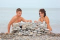 Man and woman is building construction of pebbles Royalty Free Stock Photo