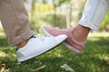 Man and woman bumping legs to say hello outdoors, closeup. Keeping social distance during coronavirus pandemic