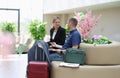 Man and woman in business suits talking and waiting for plane at airport Royalty Free Stock Photo