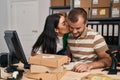 Man and woman business workers kissing and writing on notebook working at storehouse