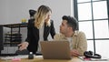 Man and woman business workers using laptop arguing at office Royalty Free Stock Photo