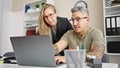 Man and woman business workers working together using laptop at the office Royalty Free Stock Photo